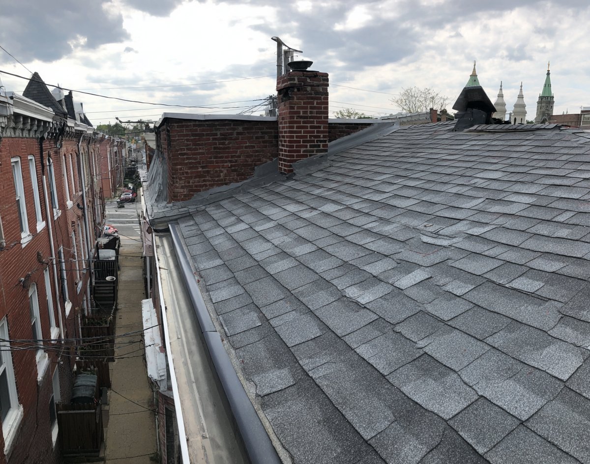 New architectural shingles and drip edge on an attached row house in Woodside
