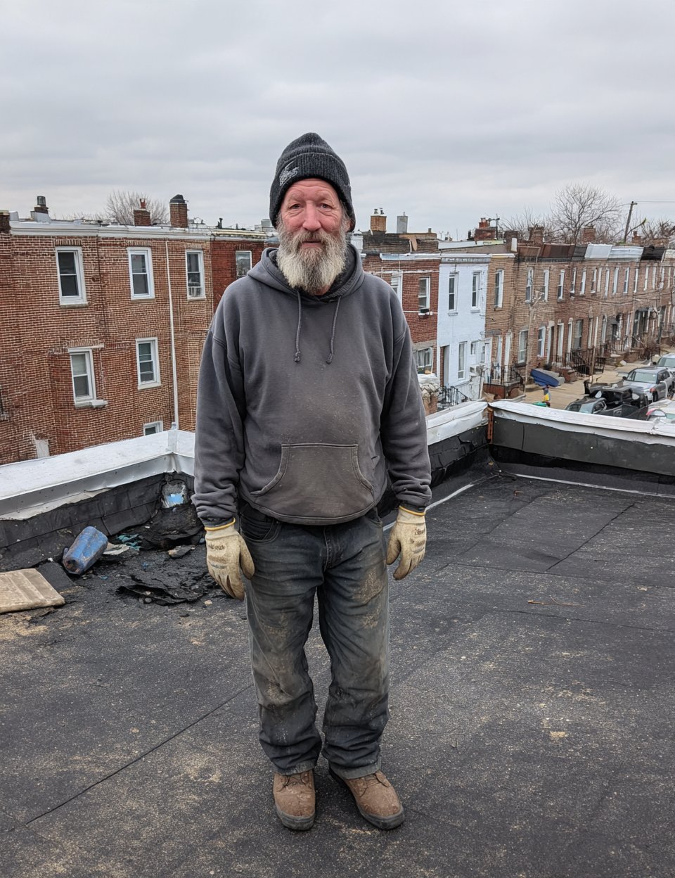 Portrait of the owner of Hearth Roofing standing on a Queens roof