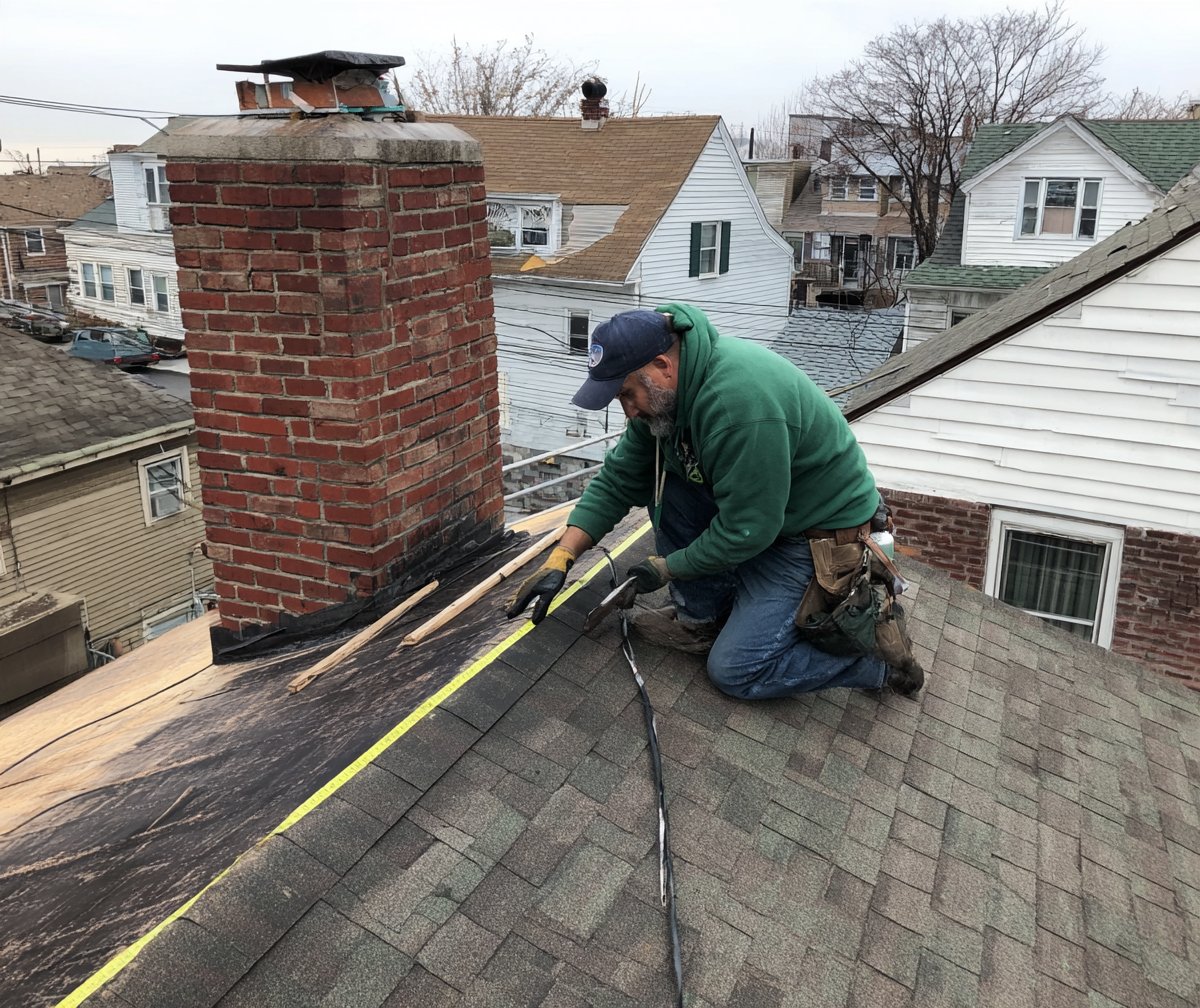 Roofer measuring a leaking section of a Queens house roof to price the repair